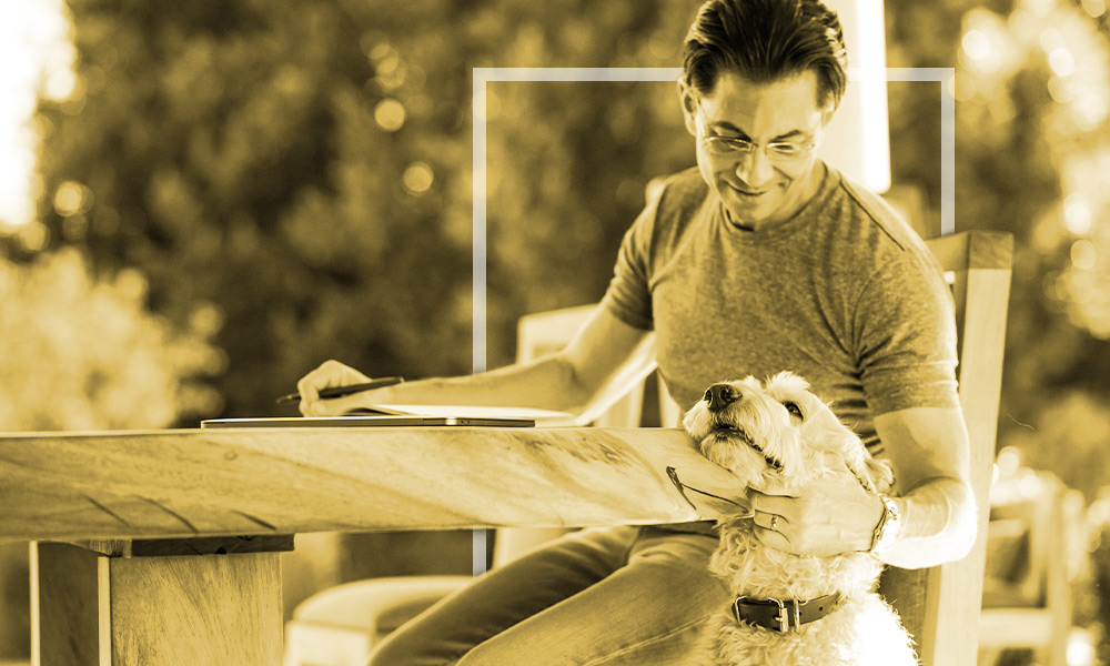 Dean Graziosi with his dog at the park.