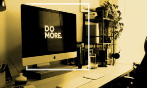 home office with desktop screensaver "Do More"
