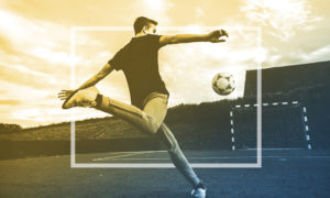 man kicking soccer goal