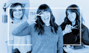 three women smiling with hair tools