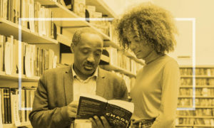 man and woman looking at a book together