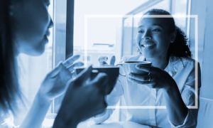 Two friends chatting over coffee