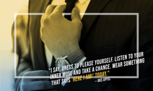 torso of man in business suit with hand fixing tie - focus is on his watch